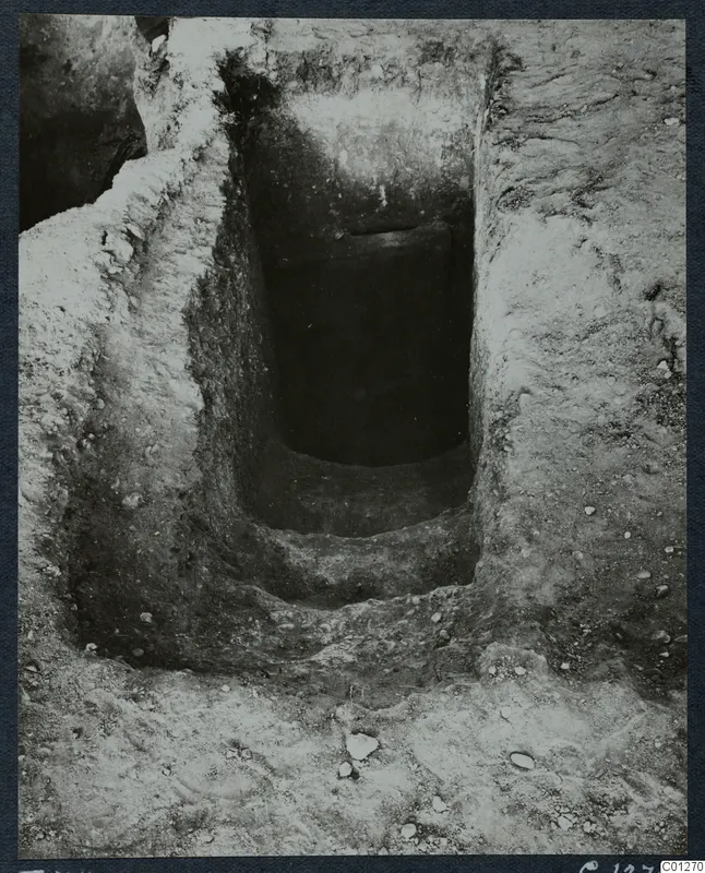 Tomb 34 at Marion during excavation, showing a rectangular cut descending in steps toward a dark opening.