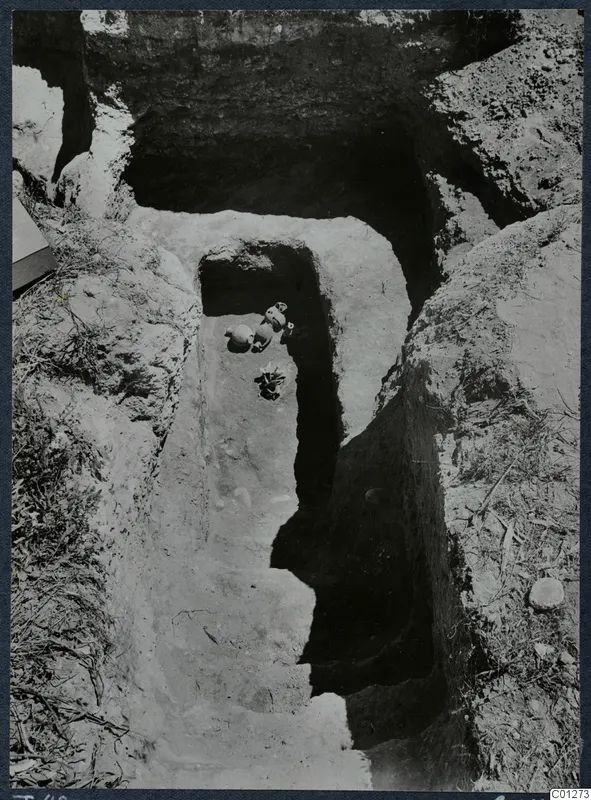 Tomb 48 at Marion during excavation, with vessels lying on the floor of a cut passage leading to the tomb.