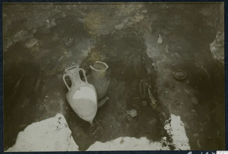 Two pottery vessels, an amphora and a jar, among small finds in an excavated tomb at Marion
