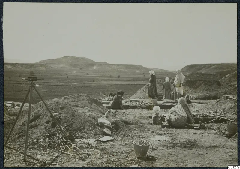 Women and a child working in an excavation at Marion, with a white dog lying on the spoil heap.