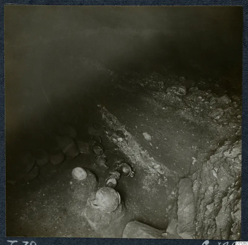 Tomb 39 at Marion during excavation, with pottery vessels lying in situ among stones