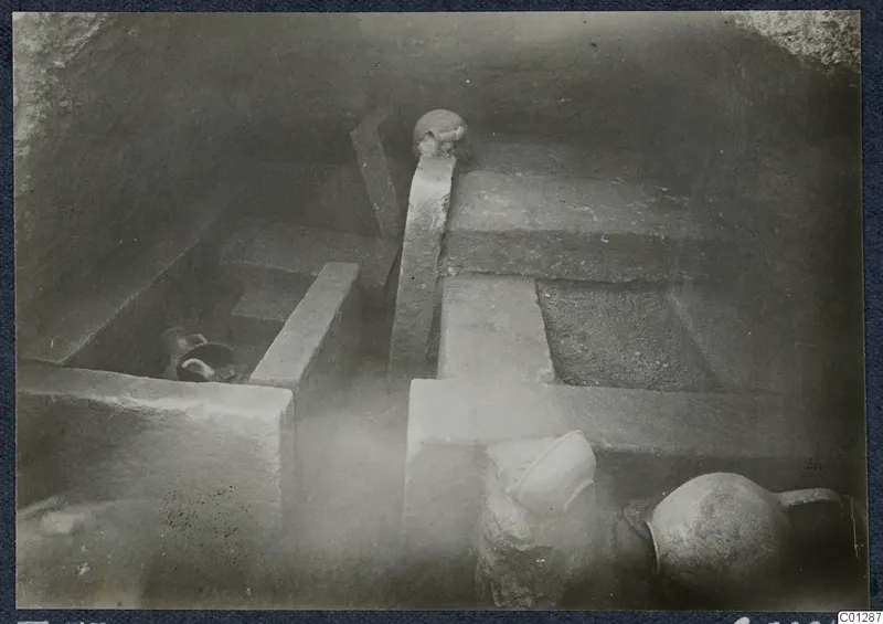 Tomb 53 at Marion during excavation, showing rock-cut ledges with pottery vessels in place
