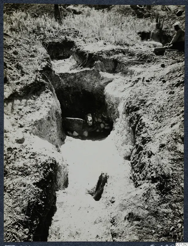 Tomb 64 at Marion: a sloping dromos leading to the open entrance of a tomb cut into the earth.