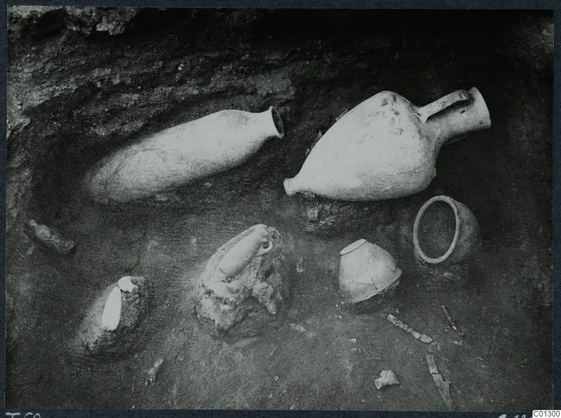 Tomb 60 at Marion during excavation, with pottery vessels and sherds lying on the tomb floor