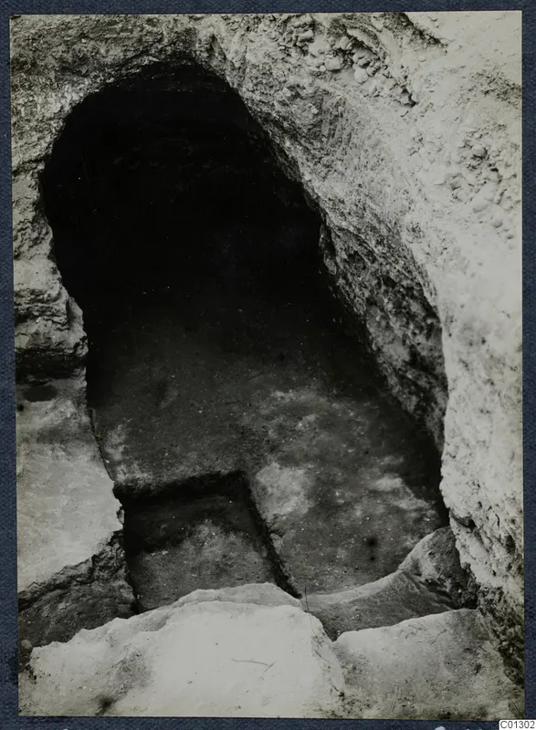 Tomb 61 at Marion during excavation: arched entrance and stepped passage cut into pale rock