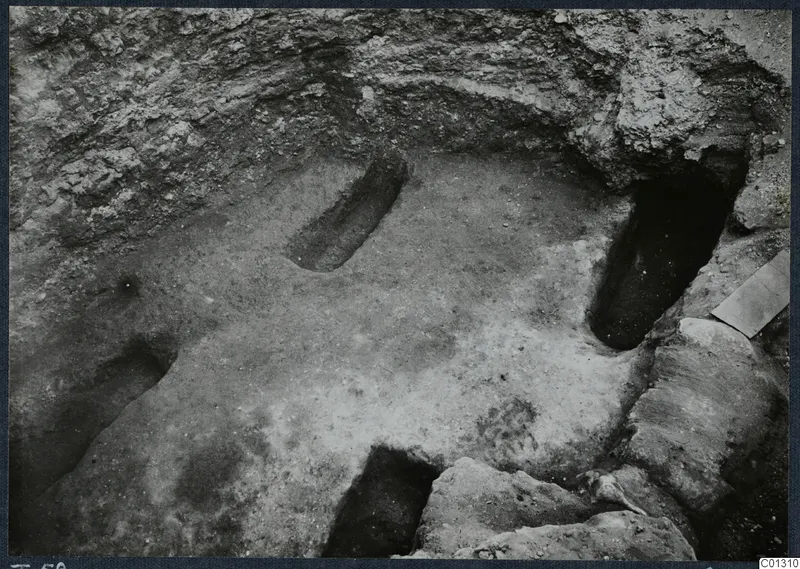 Tomb 58 at Marion during excavation, with stones in the foreground