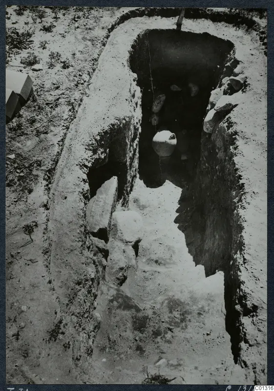 Tomb 31 at Marion during excavation, with a white vessel visible inside the chamber