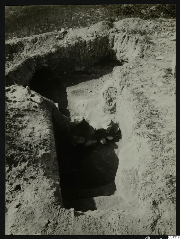 Tomb 15 at Marion during excavation, with a sloping cut leading down to the dark tomb entrance.