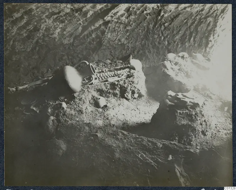 Skeleton and pottery vessels lying in the interior of Tomb 72 at Marion
