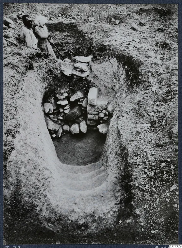Tomb 73 at Marion: a stepped dromos leads down to a tomb entrance partly blocked by stacked stones