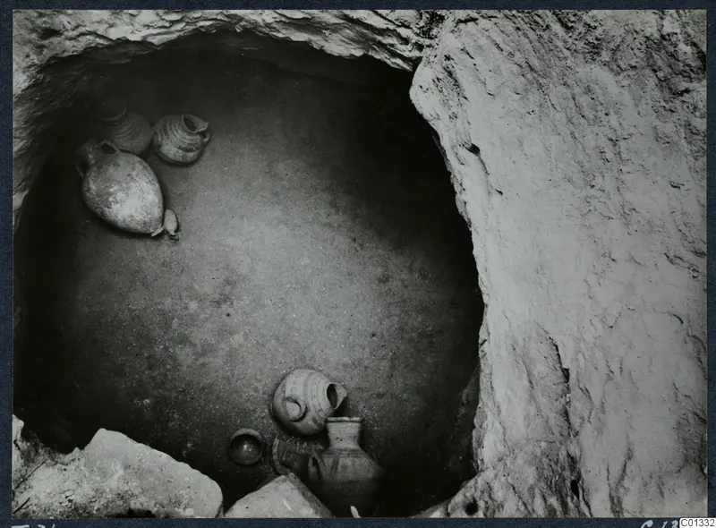 Marion Tomb 71 interior, with pottery vessels lying on the chamber floor