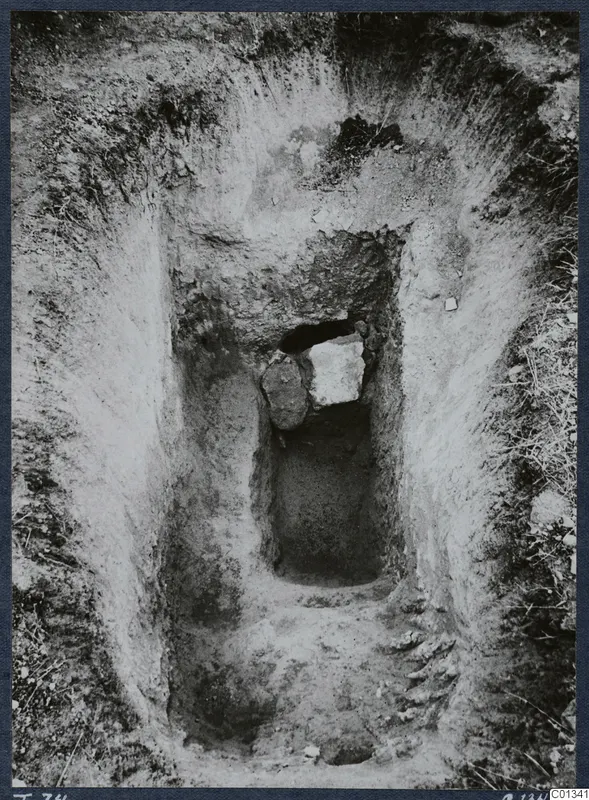 Tomb 74 at Marion during excavation, with a dromos cut into the soil and a blocked tomb entrance.