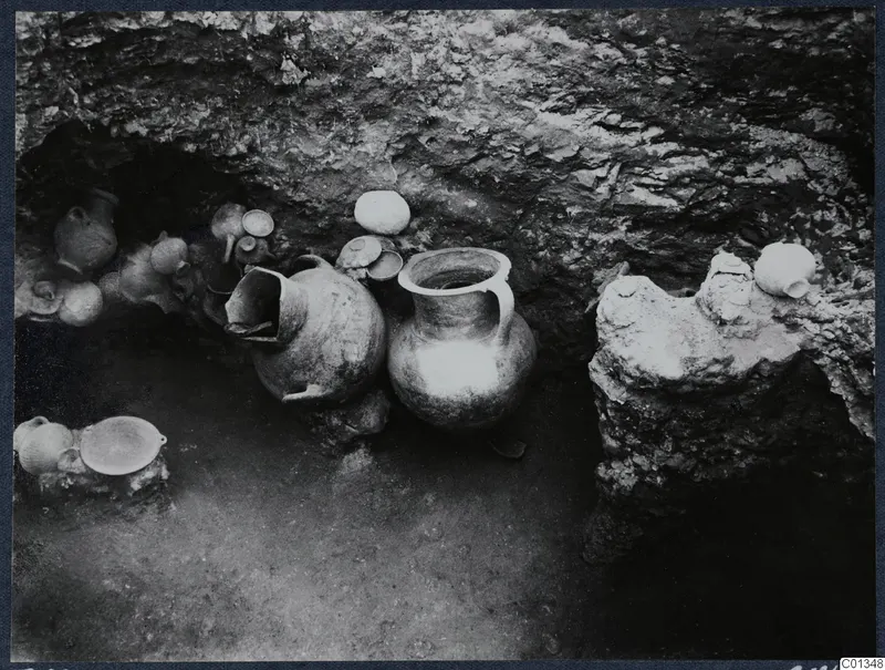 Pottery vessels in situ inside rock-cut Tomb 69 at Marion during excavation