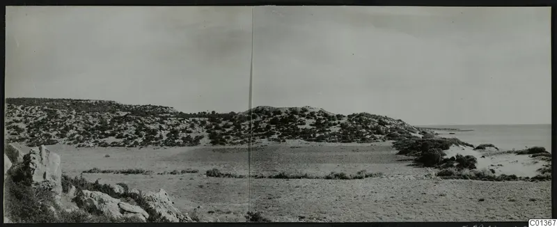 Panoramic view of Nitovikla on the Karpas peninsula, with scrubby hills, open ground and the sea on the right.