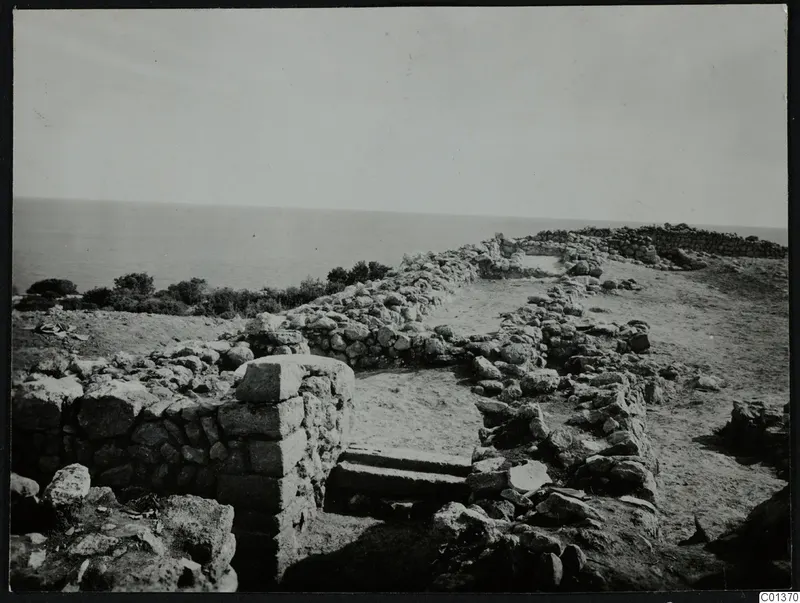Stone foundations and a stepped feature at Nitovikla on the Karpas, with the sea beyond.