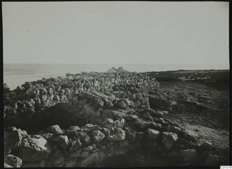Rough stone wall remains running towards the sea at Nitovikla on the Karpas peninsula