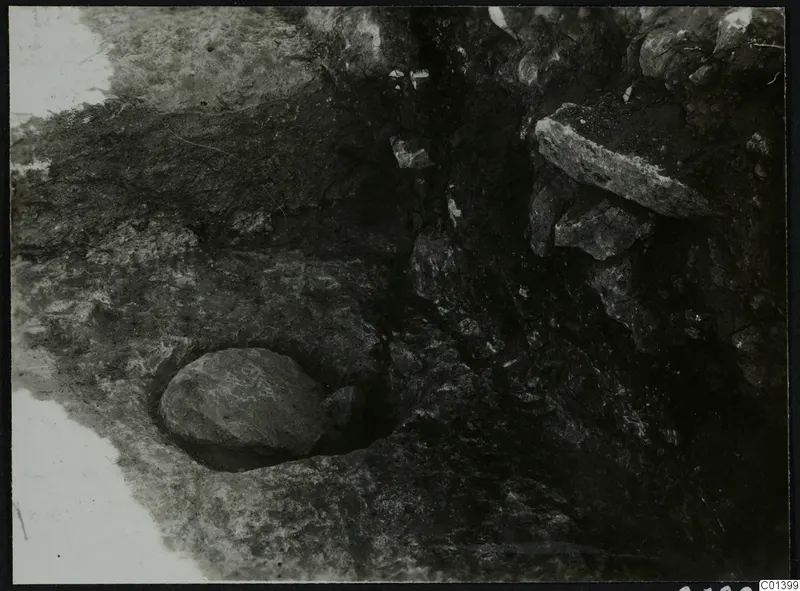 Nitovikla, Karpas Peninsula: stones exposed during excavation, with a rounded stone set in a cut in the soil