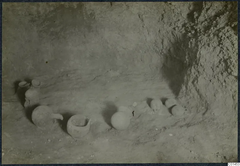 Pottery vessels lying on the sandy floor of Tomb 4.b at Ayios Iakovos during excavation