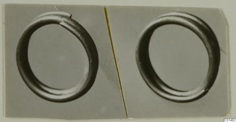 Two plain ring-shaped objects shown side by side in grey-toned photographs mounted on a card