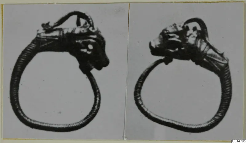 Two views of a gold ring with an animal-like head at the top