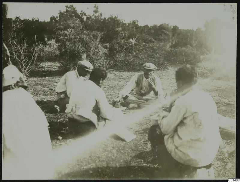 People sitting on bare ground among scrub at Nitovikla on the Karpas peninsula