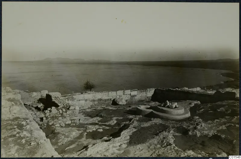 Ruined stone wall and a circular stepped base in the foreground, with the sea beyond, at Vouni palace