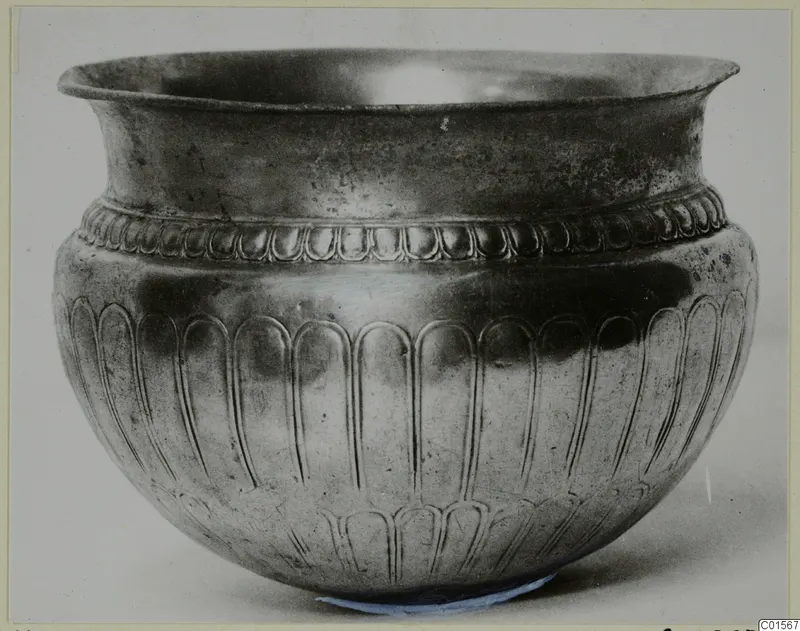 Silver vessel from Vouni 292 with a flared rim and embossed lobed decoration on the body