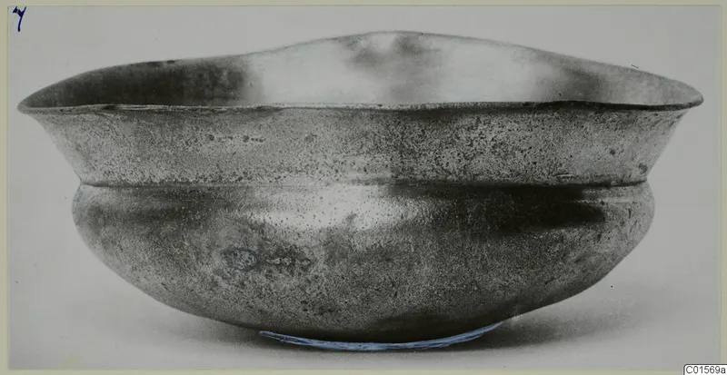 Silver bowl with a flared rim and rounded body, photographed from the side against a plain pale background.