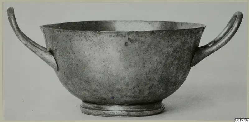Silver cup from Vouni with two looped handles and a ring foot, shown in side view.