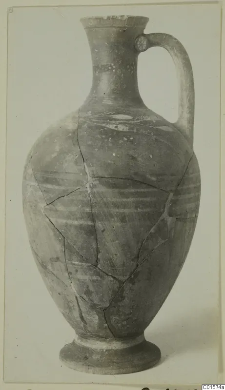 Pottery jug with a tall neck, single strap handle and horizontal painted bands, reconstructed from fragments