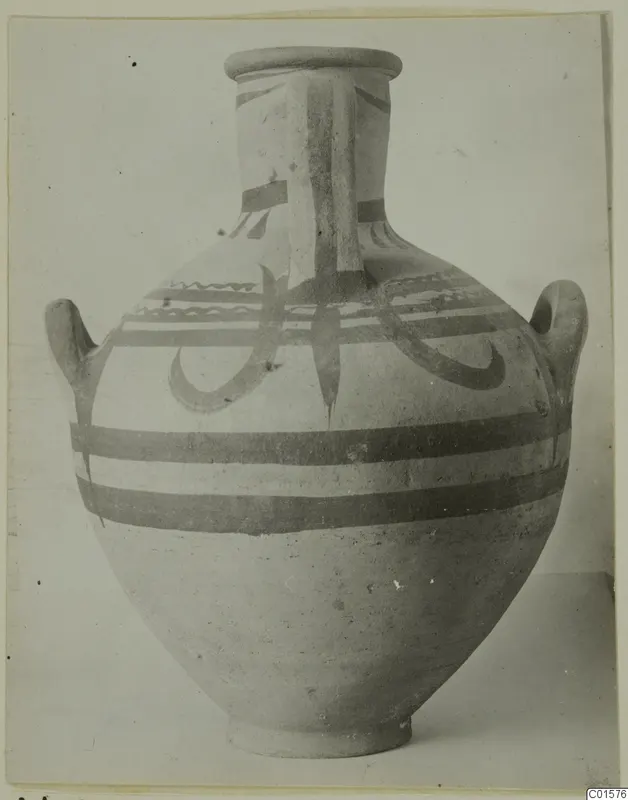 Large two-handled jar with a wide neck, painted with dark horizontal bands and curving motifs, shown against a plain background