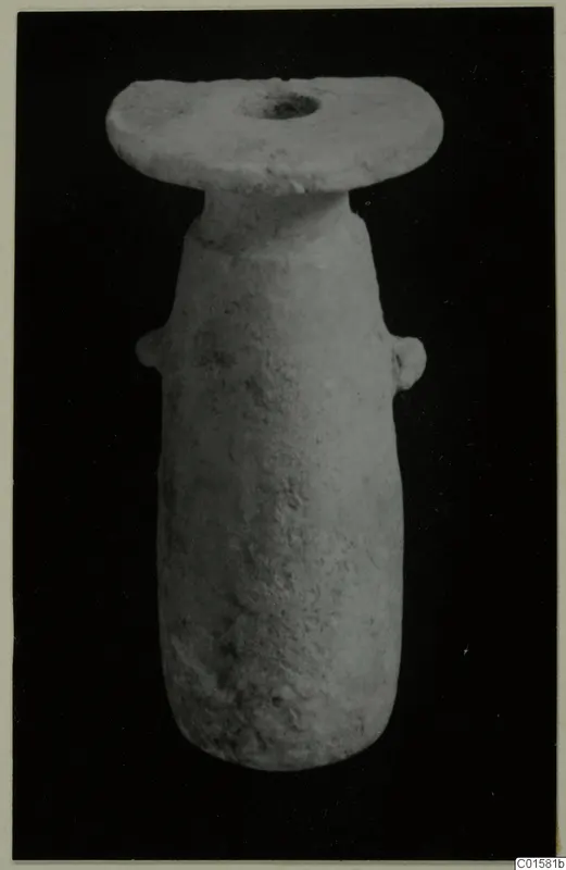 Alabaster vessel from Vouni with a flat disc-shaped mouth and two small lug handles, against black