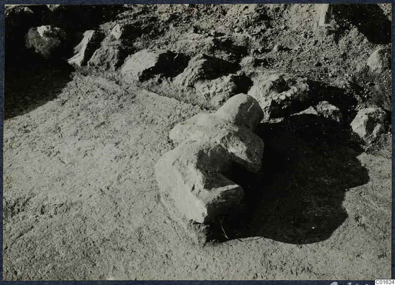Carved stone find lying partly buried in the soil among rubble stones at Vouni Palace