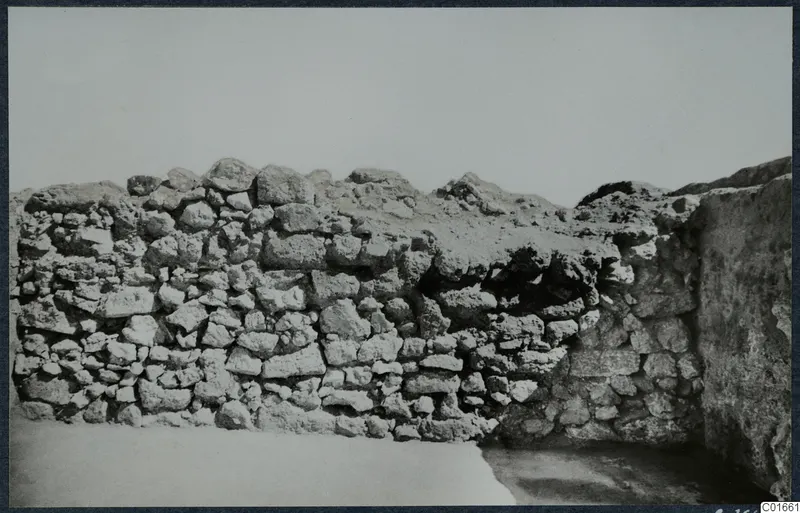 Excavated stone wall at the palace at Vouni, built of rough rubble blocks with a rubble-topped section.