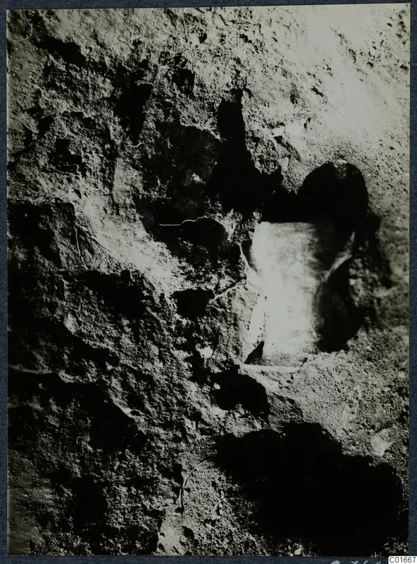Close view of finds in situ at Vouni: a pale stone set into a pitted, rough excavated surface