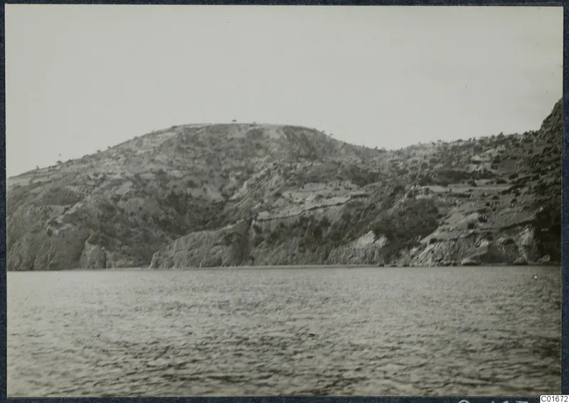 Rocky hill rising above the sea at Vouni, seen from the water