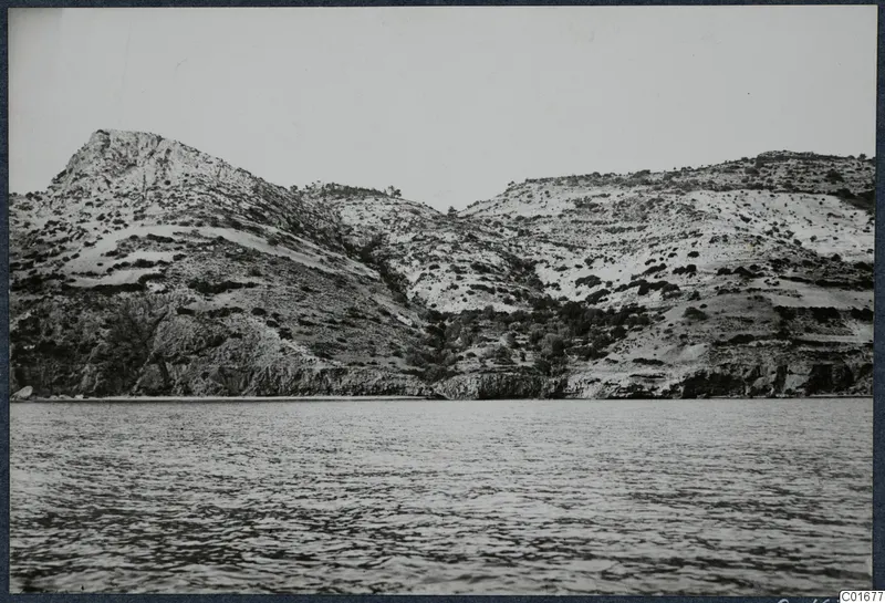 Scrub-covered hills and rocky slopes rising above the sea at Vouni