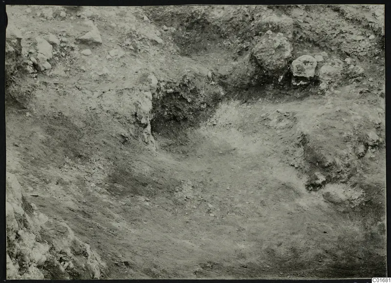 Excavation at Petra tou Limniti showing exposed stones and dug soil in a trench.