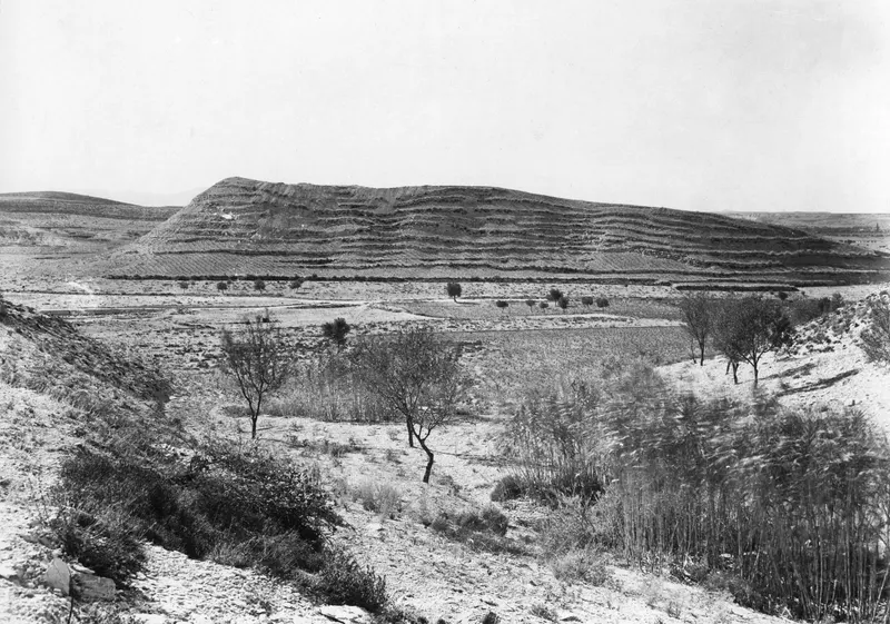 The Acropolis of Idalion seen from the east: a long flat-topped hill with stepped, banded slopes