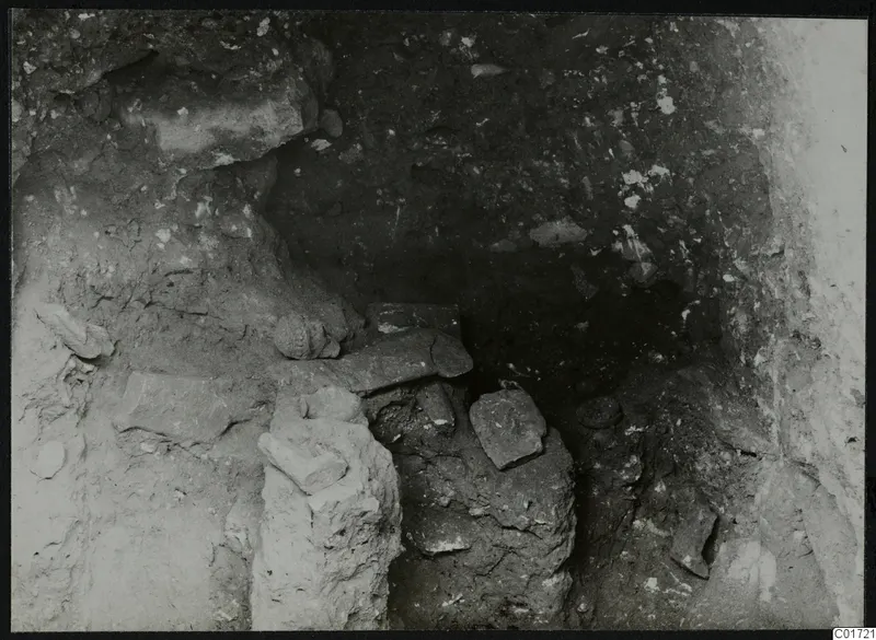 Sculpted head and stone blocks in situ in the cult room, north gallery, at Kition
