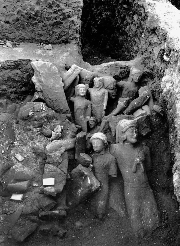 Larger sculptures lying together in the cult room deposit at Kition, with fallen blocks and earth around them