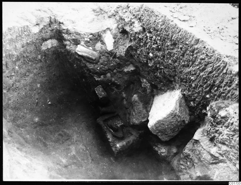 Central pit at Kition with stone objects in situ in the excavated soil