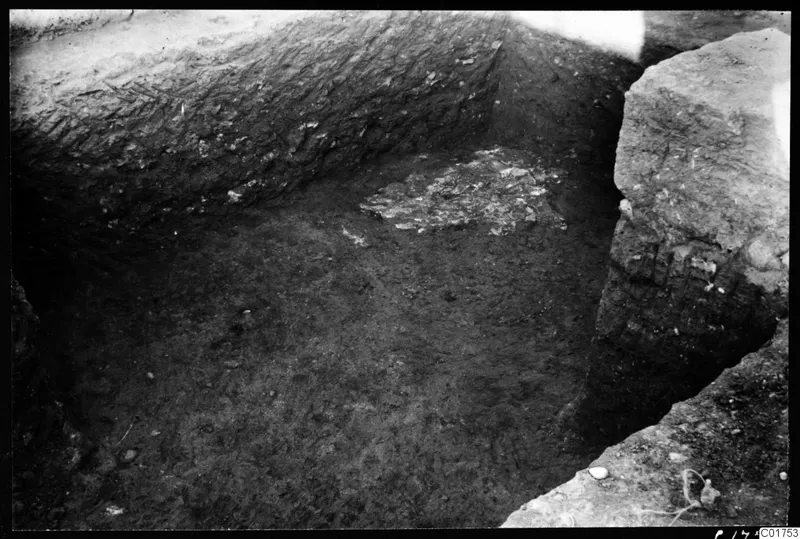Excavated corner of a cult room at Kition, with a patch of broken floor material lying in the trench