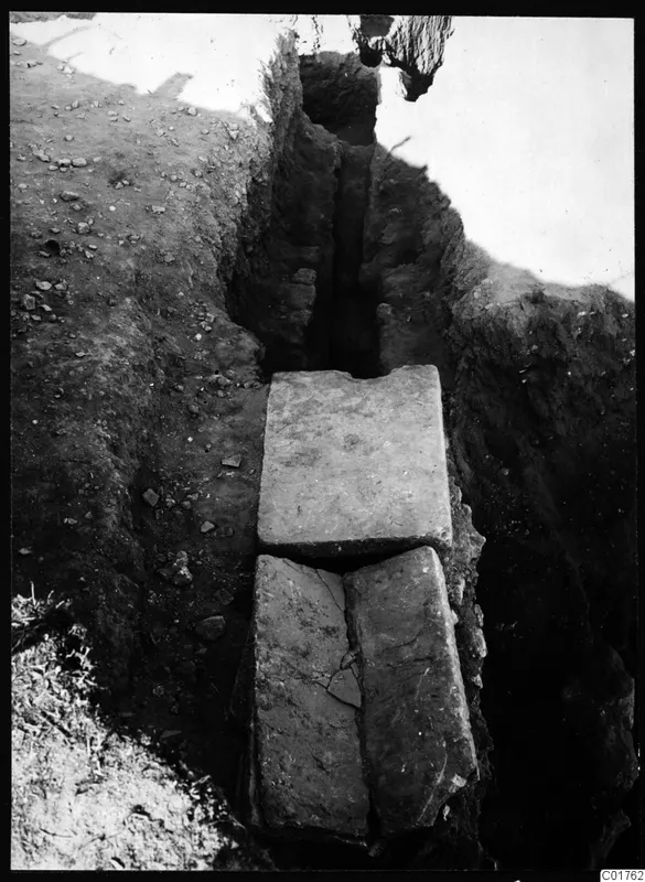 Water channel at Kition, covered with flat stone slabs in an excavation trench.