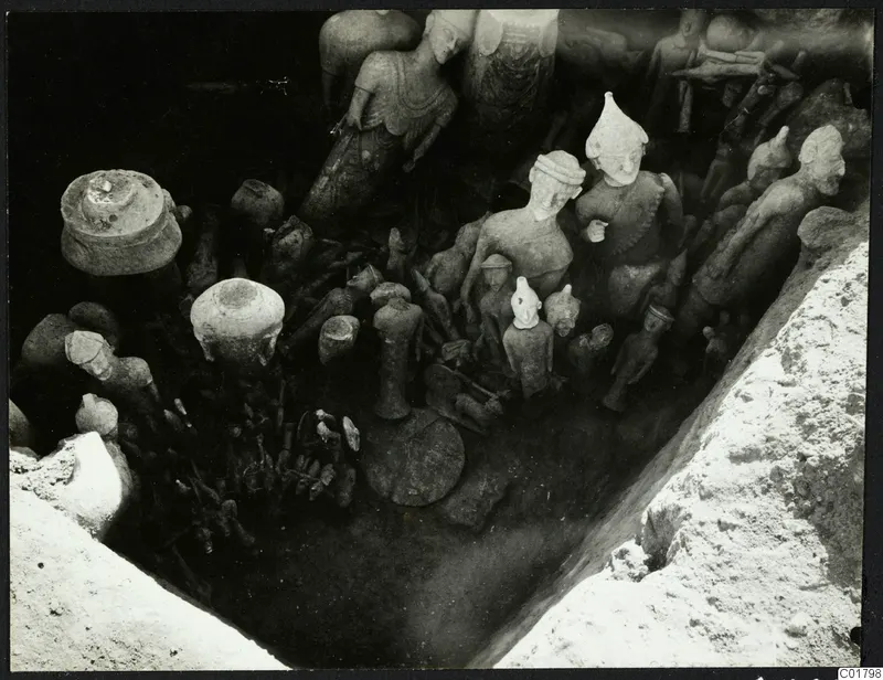 Sculptures and vessels lying in situ in an excavated trench at Ayia Irini