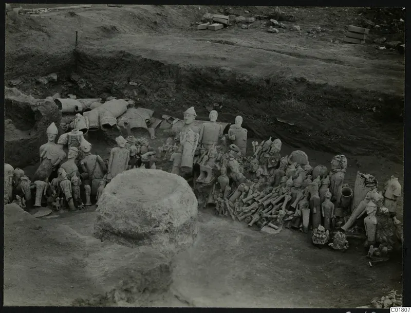 Excavation at Ayia Irini with many clay figures and fragments lying in situ in the trench