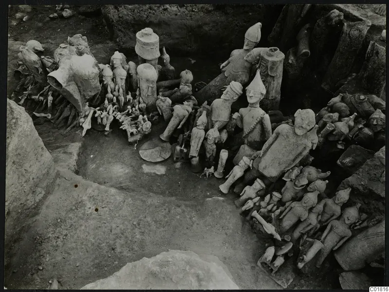 Clay figurines, animal shapes and cylindrical stands lying in excavation square L 9-10 at Ayia Irini