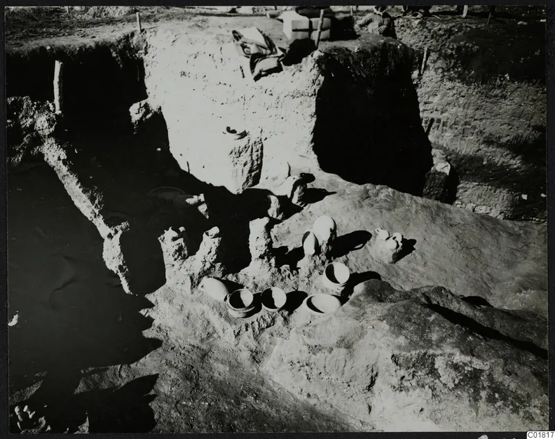 In situ pottery vessels lying in an excavated trench at Ayia Irini