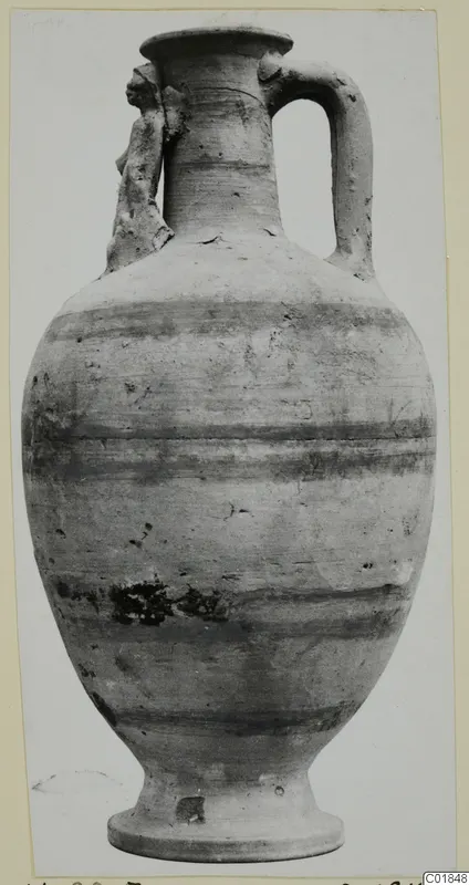 Pottery White Painted VII, a tall one-handled vessel with horizontal bands and a small applied figure on the shoulder