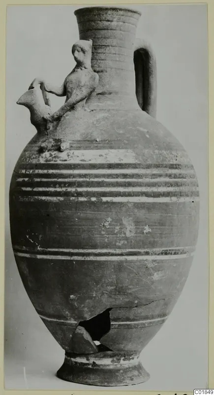 Bichrome-Red jug with a small figure on the shoulder and a bird-headed spout